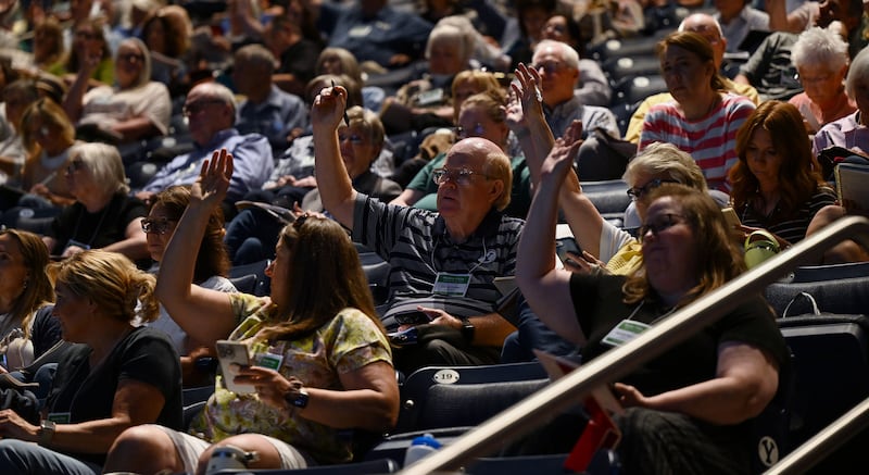 Audience members who are currently serving in Primary raise their hands in the Marriott Center for 2024 BYU Education Week.