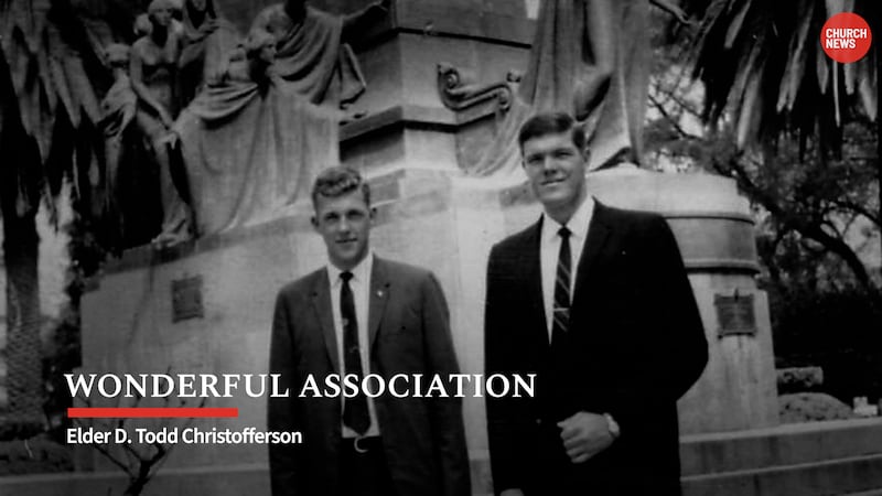 Two young missionaries stand in front of a statue in this black-and-white photo with "Wonderful Association" written on the bottom left.