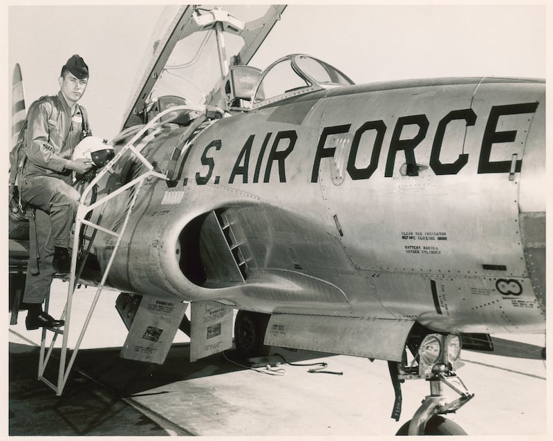 Dieter F. Uchtdorf stands next to a U.S. fighter jet.