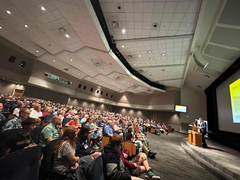 Aaron D. Franklin, right, teaches at BYU Education Week in an auditorium-style classroom as viewed from the side.