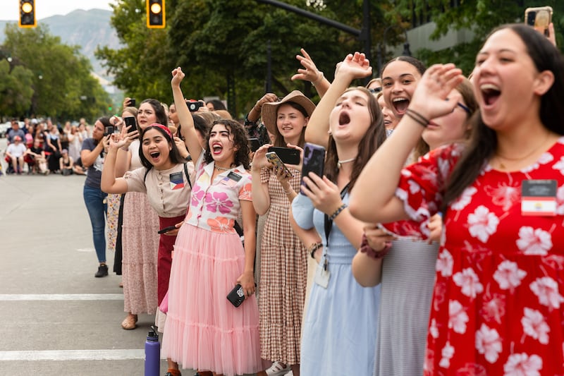 Sister missionaries cheer on the parade participants during the annual Days of ’47 Parade .