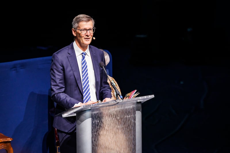 President Steven J. Lund stands behind a podium in the BYU Marriott Center.