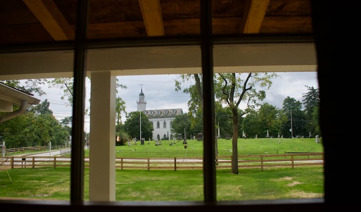 The Kirtland Ohio Temple is seen through a window of the Joseph and Emma Smith home in August 2023.
