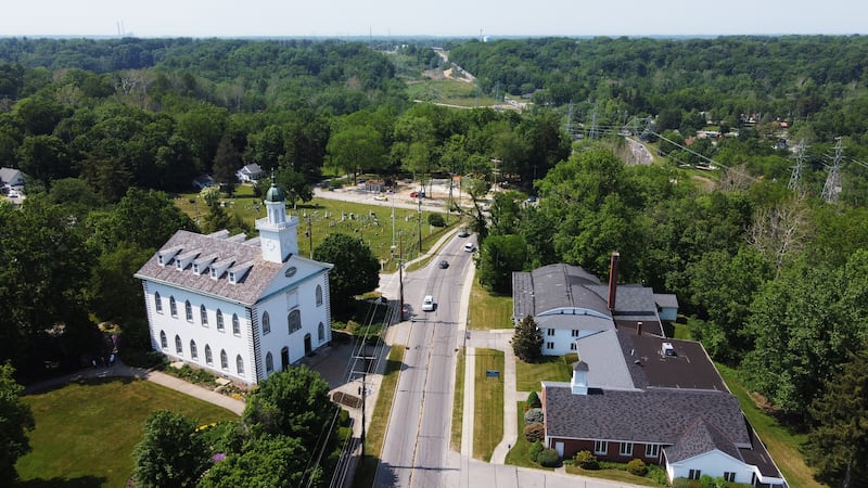 An aerial view of the Kirtland Temple, showing the cemetery next to it and the buildings across the street.