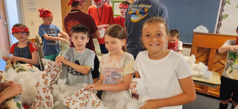 Children in the Marysville Washington Stake stuff pillows for hospice patients as part of a service project during the stake Primary day camp in Lake Stevens, Washington
