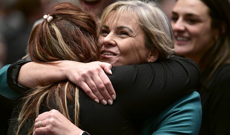 Attendees in the Conference Center in Salt Lake City hug each other before the Saturday evening session of the 194th Annual General Conference of The Church of Jesus Christ of Latter-day Saints on April 6, 2024.