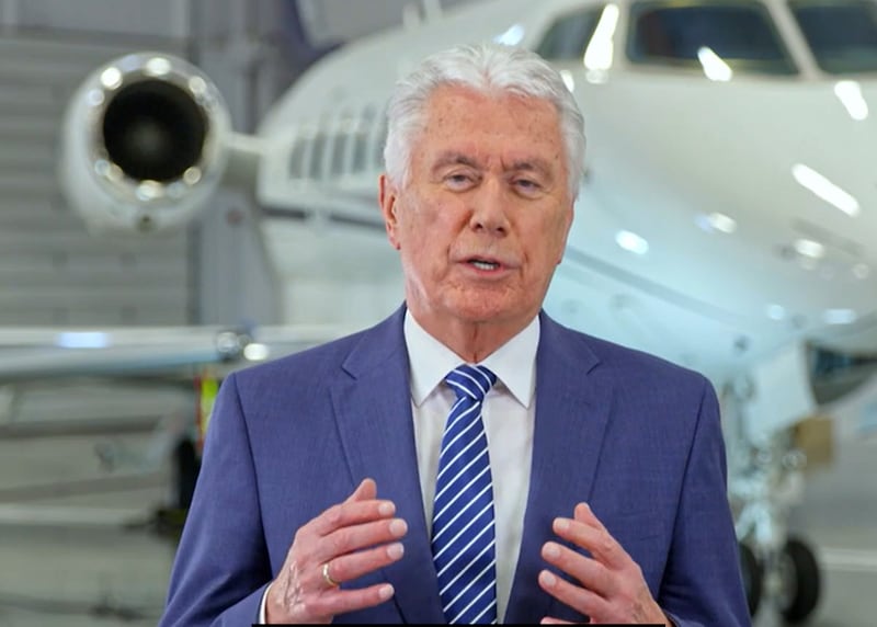 Elder Dieter F. Uchtdorf speaks in front of a jet in a hangar.